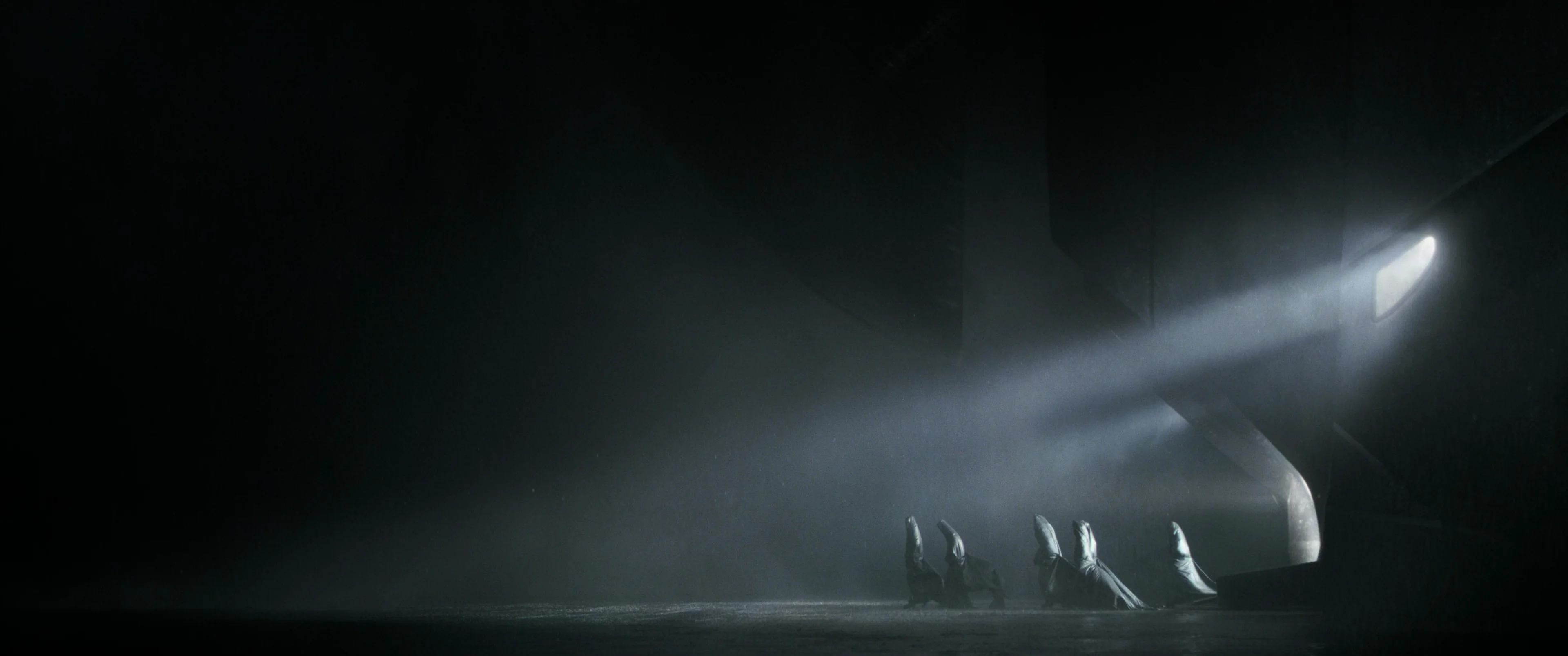Dune, robed figures in a shaft of light