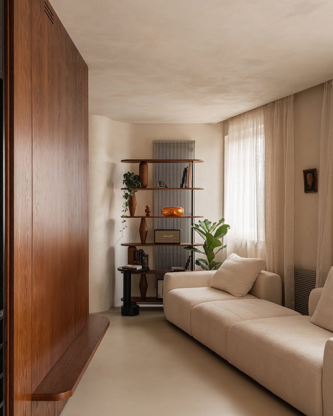Warm plaster lounge, walnut shelving