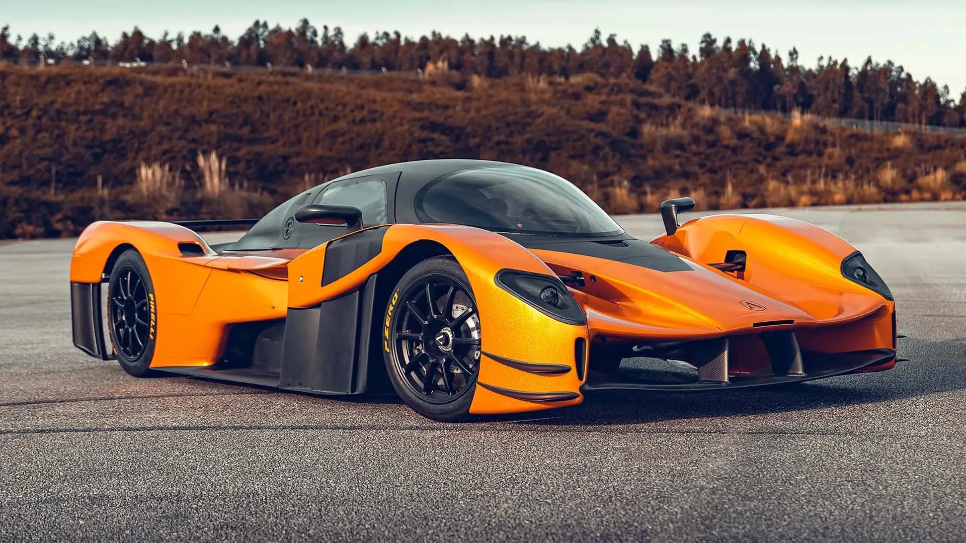 Orange track hypercar on empty tarmac