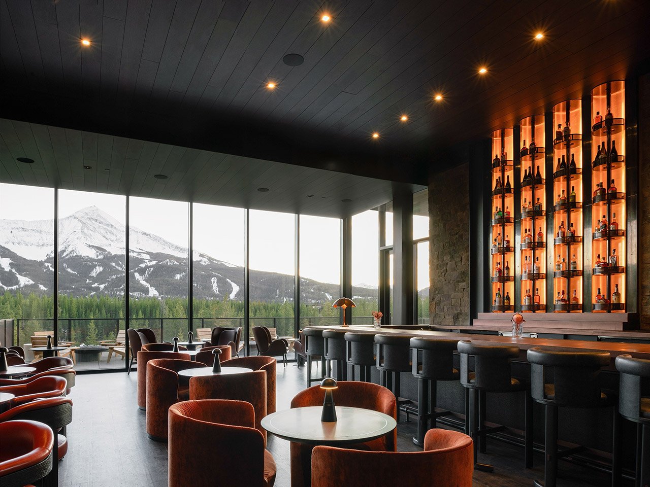 Mountain lodge bar with backlit bottle wall
