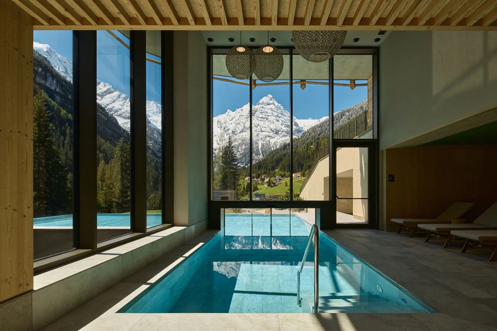 Alpine spa pool framing a snowy peak