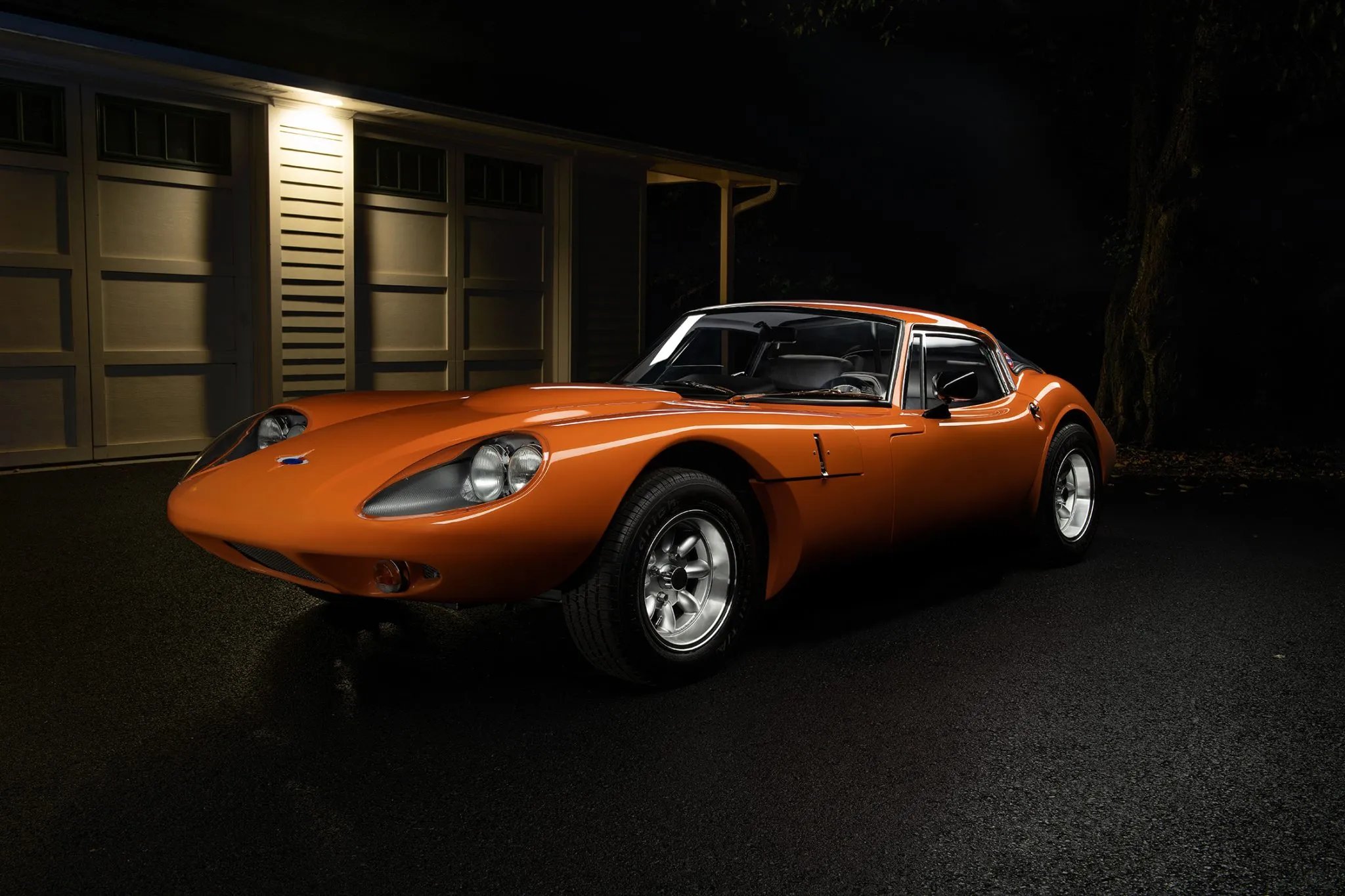 Orange sixties coupe at night