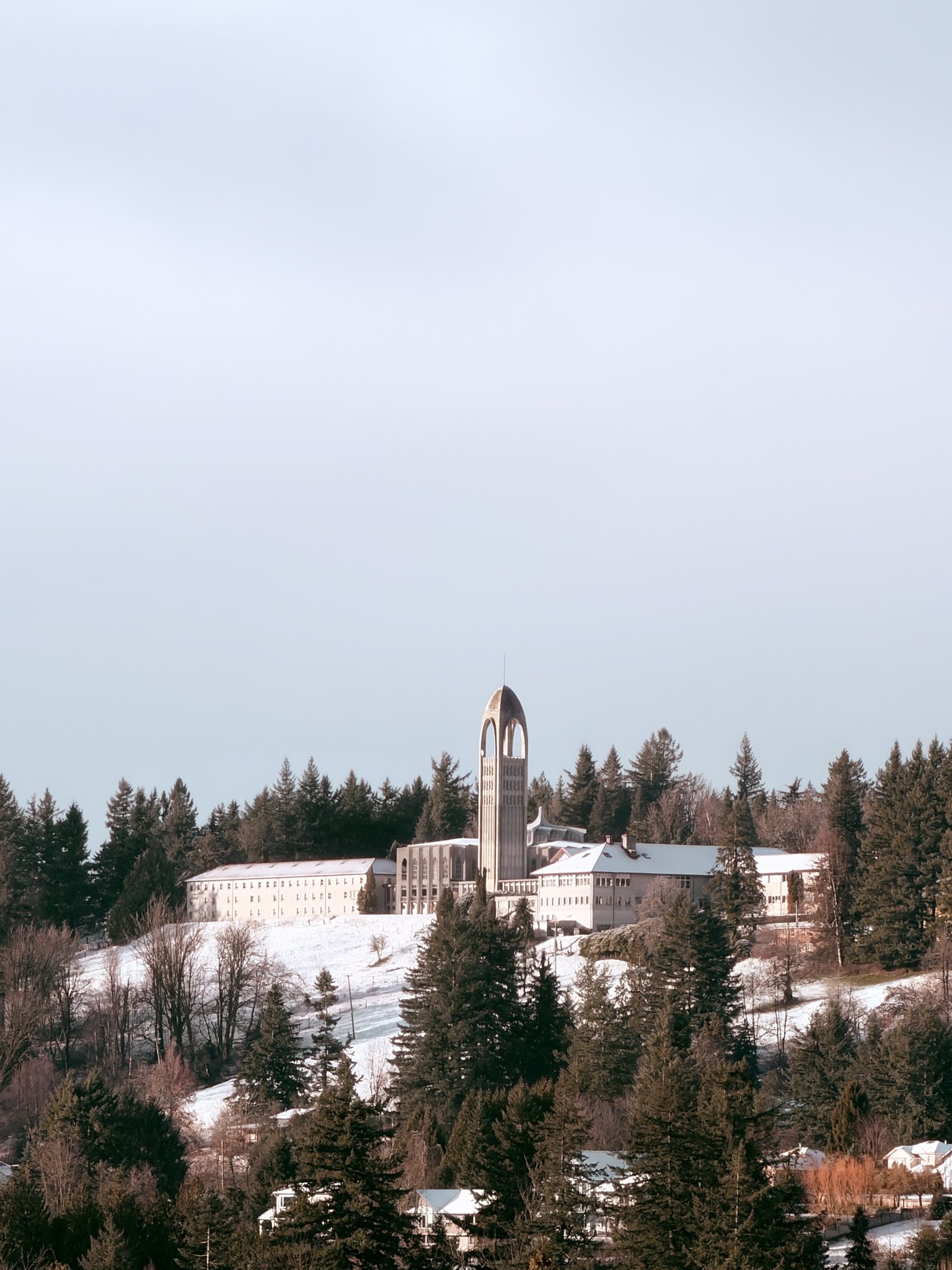 Modernist hilltop monastery in snow